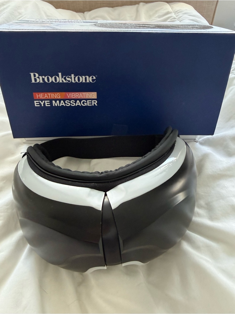 Brookstone Black and White Heating Vibrating Eye Massager with Adjustable Strap